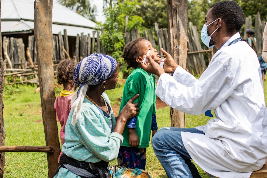 Child being administered antibiotics for trachoma infection