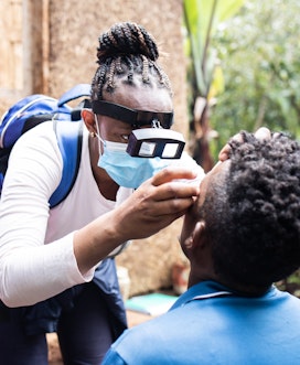 Dinknesh checking Zelalems eyes Trachoma Impact Survey Dilla Ethiopia 2022