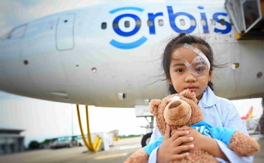 Young female patient Han from Vietnam outside the Flying Eye Hospital after sight-restoring surgery